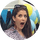 happy woman with mouth open and blue and yellow balloons behind her